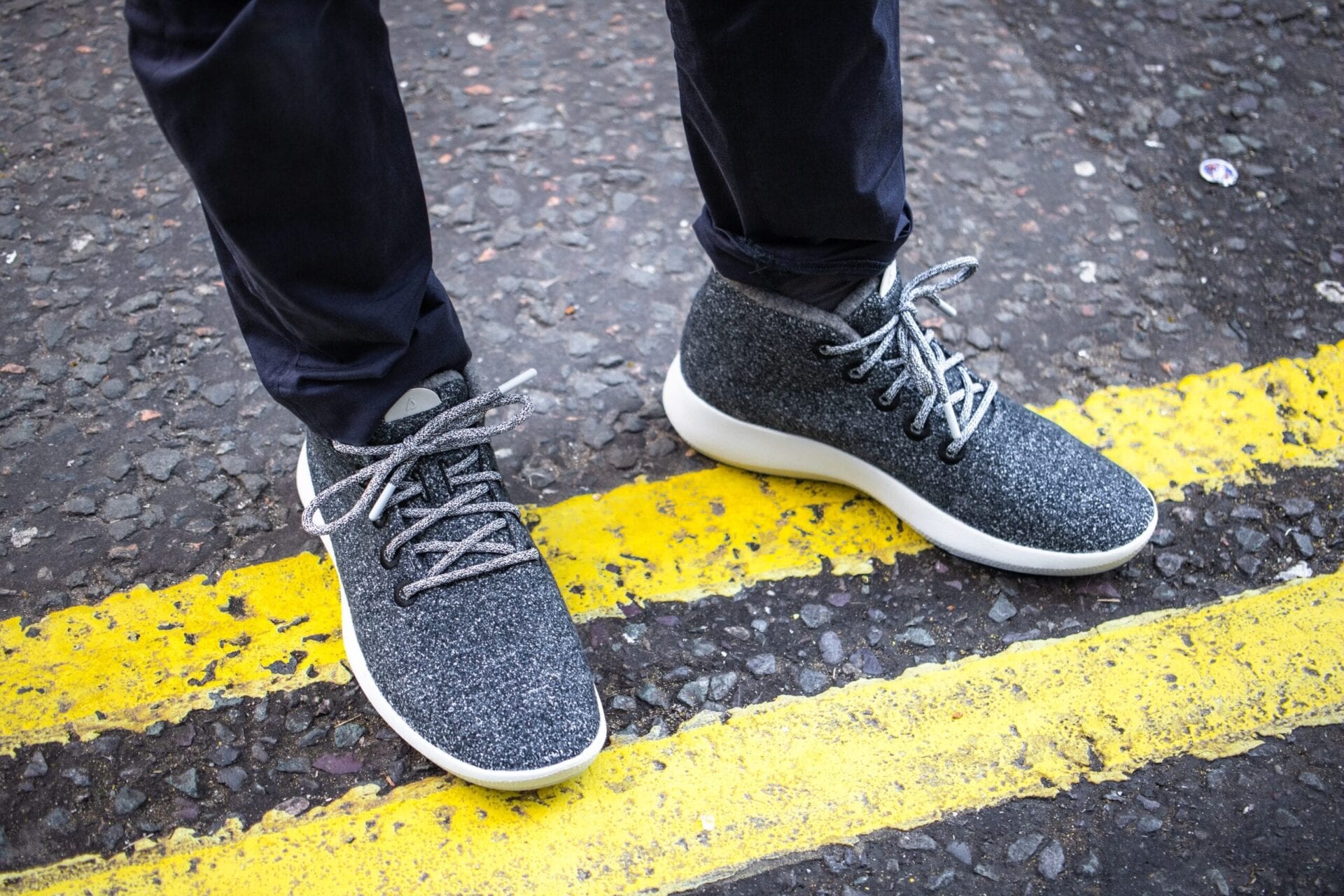 Grey sneakers on pavement