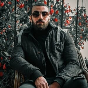 Guy wearing a dark jacket and shades