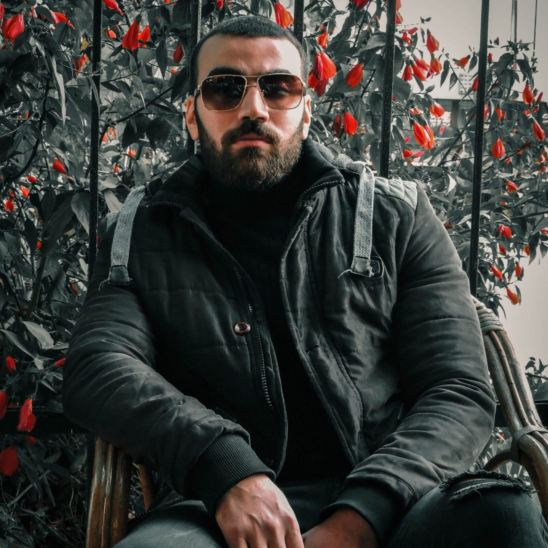 Guy wearing a dark jacket and shades